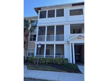 Three-story building exterior with balconies and landscaping at 4802 51St W St # 1106, Bradenton, FL 34210