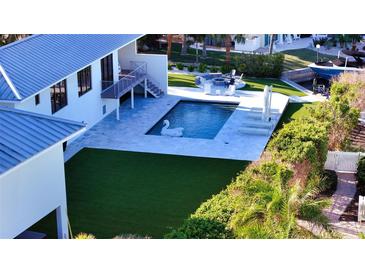 Luxury home with pool, dock, and lush landscaping at 501 Outrigger Ln, Longboat Key, FL 34228