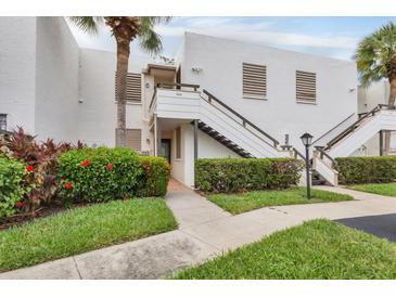 Exterior of condo building with walkway and landscaping at 542 Lakeside Dr # 542, Bradenton, FL 34210