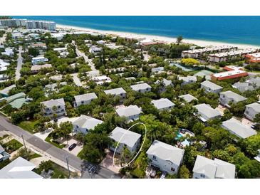 Aerial view of a beachfront property community showcasing a home with private parking at 6250 Holmes Blvd # 71, Holmes Beach, FL 34217