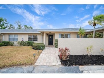Front view of a condo with a walkway and landscaping at 6884 W Country Club Ln, Sarasota, FL 34243