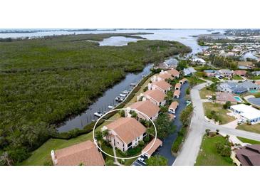Aerial view of waterfront condo community, highlighting a specific unit and shared pool at 8644 54Th W Ave # 8644, Bradenton, FL 34210