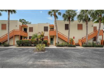 Tan two-story building with orange stairs and palm trees at 153 Wild Palm Dr # 153, Bradenton, FL 34210