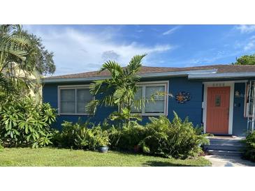 Charming bungalow with a bright blue exterior, landscaping, and a welcoming front porch at 3008 7Th N Ave, St Petersburg, FL 33713