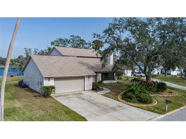 Two-story house with attached garage, landscaping, and a paved driveway at 8006 Oak Dr, Palmetto, FL 34221