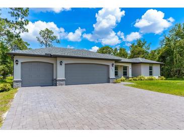 New three-car garage home with paver driveway at 4892 Hillman Ter, North Port, FL 34288
