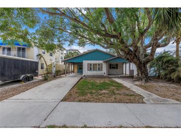 Charming teal home with a spacious yard and mature tree at 554 Canal Rd, Sarasota, FL 34242