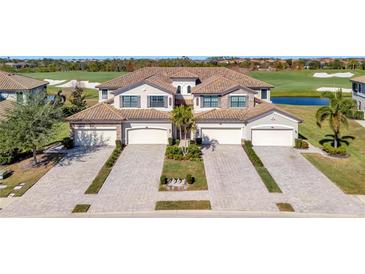Luxury 3-unit building with tile roofs, attached garages, and a golf course view at 5904 Wake Forest Run # 102, Bradenton, FL 34211