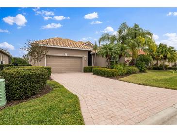 Single-story home with a two-car garage and landscaped front yard at 6411 41St E Ct, Sarasota, FL 34243