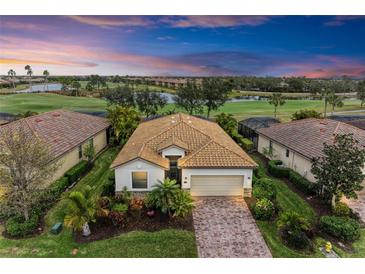 Aerial view of single-Gathering home with tile roof, golf course views at 6933 Quiet Creek Dr, Bradenton, FL 34212