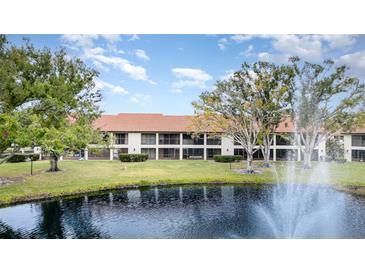 Community pond with fountain in front of condo building at 764 Avenida Estancia # 208, Venice, FL 34292