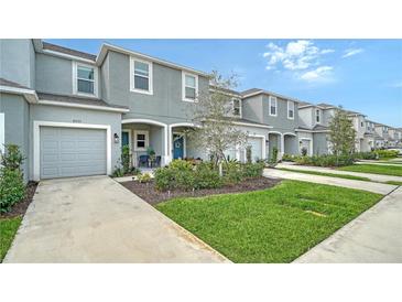 Two-story townhome with attached garage and landscaped front yard at 8533 Lunar Skye St, Sarasota, FL 34241