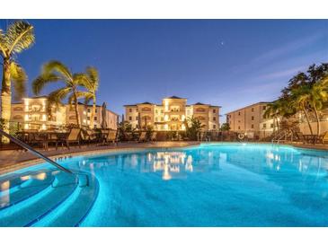 Night view of resort-style pool with building reflection at 9203 Griggs Rd # B304, Englewood, FL 34224