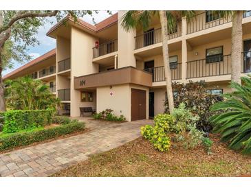 Building exterior showcasing landscaping and walkway at 104 Capri Isles Blvd # 112, Venice, FL 34292
