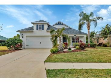 White one-story house with a two-car garage, landscaping, and palm trees at 12240 Whisper Lake Dr, Bradenton, FL 34211