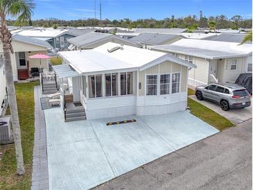 Aerial view of a mobile home with a paved driveway and surrounding community at 3333 26Th E Ave # 1241, Bradenton, FL 34208