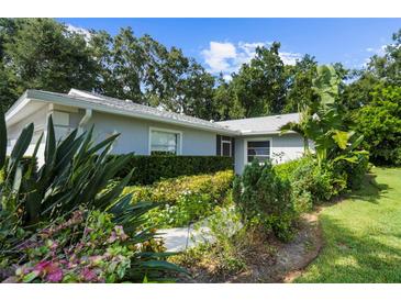 Well-maintained home with lush landscaping and a walkway at 5916 Bonaventure Pl, Sarasota, FL 34243