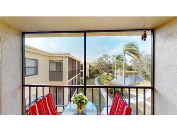 Screened balcony overlooks a peaceful lake and lush landscaping at 305 30Th W Ave # A308, Bradenton, FL 34205