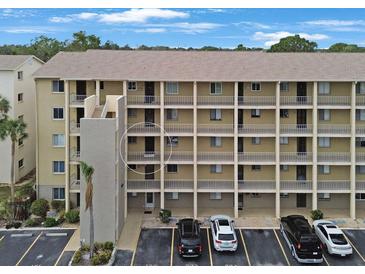 Exterior view of a multi-story building with parking at 3622 Lake Bayshore Dr # K302, Bradenton, FL 34205