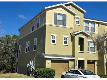 Two-story townhome featuring a front-entry garage, neutral paint scheme, and well-kept landscaping at 8889 White Sage Loop, Lakewood Ranch, FL 34202