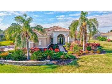 Single-story home with tile roof, lush landscaping, and paver driveway at 210 166Th Ne St, Bradenton, FL 34212