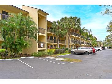 Two-story condo building with ample parking and lush landscaping at 425 30Th W Ave # C102, Bradenton, FL 34205