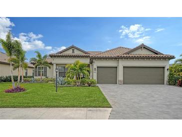 One-story home with tile roof, two-car garage, and landscaped yard at 4810 Sparkling Sea Ln, Bradenton, FL 34211
