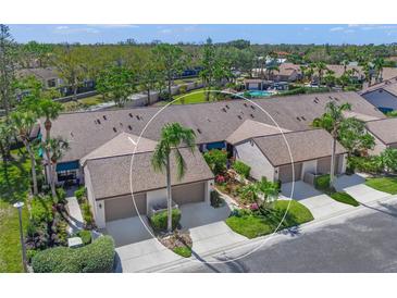 Aerial view of charming villa community with lush landscaping and community pool at 5958 Clubside Dr, Sarasota, FL 34243