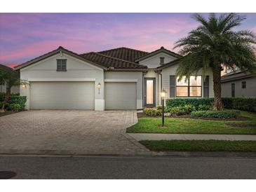 Beautiful two-story home with a three-car garage and lush landscaping at 6519 Rosehill Farm Run, Bradenton, FL 34211