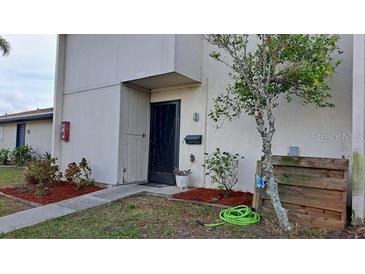 Condo exterior with a front entrance, landscaping, and walkway at 1007 Longfellow Cir, Sarasota, FL 34243