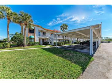 Two-story condo building with carport parking and lush landscaping at 4366 Madeira Ct # 3356, Sarasota, FL 34233