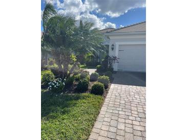 Well-maintained home with attractive landscaping and paved driveway at 4882 Maymont Park Cir, Bradenton, FL 34203