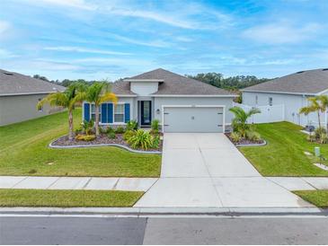 Single-story home with gray siding, blue shutters, and landscaping at 6609 114Th E Ave, Parrish, FL 34219