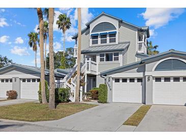 Two-story townhome with attached garage and palm trees at 1275 Siesta Bayside Dr # 1275, Sarasota, FL 34242