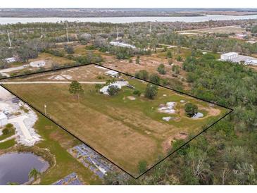 Aerial view of property showing home, expansive land, and pond at 19990 E State Road 64, Bradenton, FL 34212