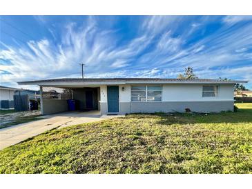 Ranch-style home with carport, and a well-manicured lawn at 360 Flamingo Rd, Venice, FL 34293