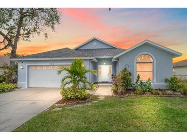 Cute one-story home with a landscaped lawn, attached garage, and a walkway to the front door at 3712 62Nd E Ave, Bradenton, FL 34203