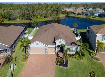 Aerial view of a single-Gathering home with a large backyard and a lake at 5522 69Th E Pl, Ellenton, FL 34222