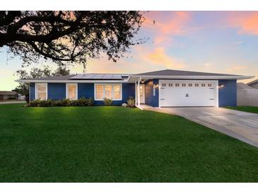 Stunning blue home with solar panels and a spacious yard at 6902 22Nd W Ave, Bradenton, FL 34209