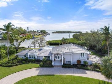 Luxury waterfront home with circular driveway, offering stunning water views at 7056 Hawks Harbor Cir, Bradenton, FL 34207