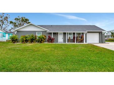 Gray house with white trim, landscaping, and a two-car garage at 905 69Th Nw St, Bradenton, FL 34209