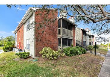 Brick building exterior with screened balcony and landscaping at 9100 Dr Martin Luther King Jr N St # 1302, St Petersburg, FL 33702