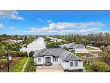 Aerial view of a single-Gathering home with water access at 10155 Hallendale Dr, Port Charlotte, FL 33981