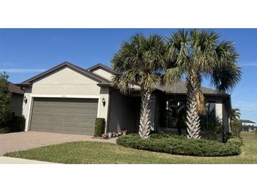 Single-story home with two-car garage and landscaped yard at 2536 Marton Oak Blvd, North Port, FL 34289