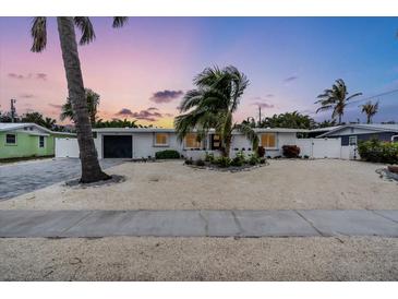 Charming mid-century modern home with a landscaped front yard at 306 66Th St, Holmes Beach, FL 34217