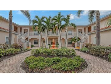 Community courtyard with fountain and lush landscaping at 4228 Central Sarasota Pkwy # 1013, Sarasota, FL 34238