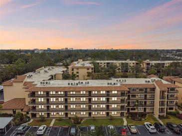 Aerial view of condo building with parking and landscaping at 635 30Th Ave W # F206, Bradenton, FL 34205