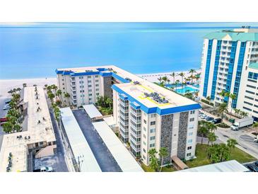 Aerial view of beachfront condo building with parking and pool at 800 Benjamin Franklin Dr # 202, Sarasota, FL 34236
