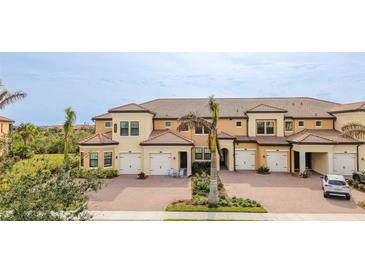 Attractive three-story townhome with two-car garage and manicured landscaping at 10031 Crooked Creek Dr # 201, Venice, FL 34293