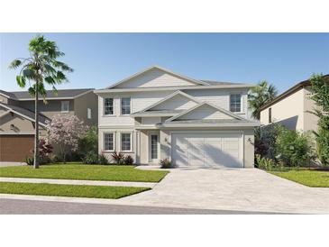 Two-story house with white siding, gray roof, and a two-car garage at 12239 Stirrup Dr, Dade City, FL 33525
